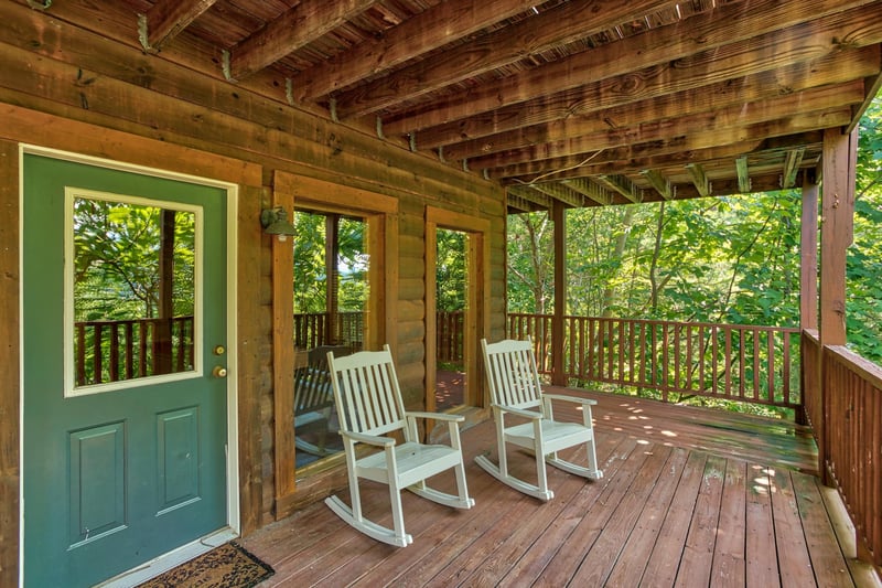 rocking chairs on a covered deck at angels majestic view a 3 bedroom cabin rental located in pigeon forge