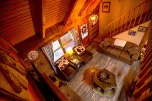 Cozy up in your rustic cabin retreat with warm wood beams, comfortable leather seating, and charming vintage touches.