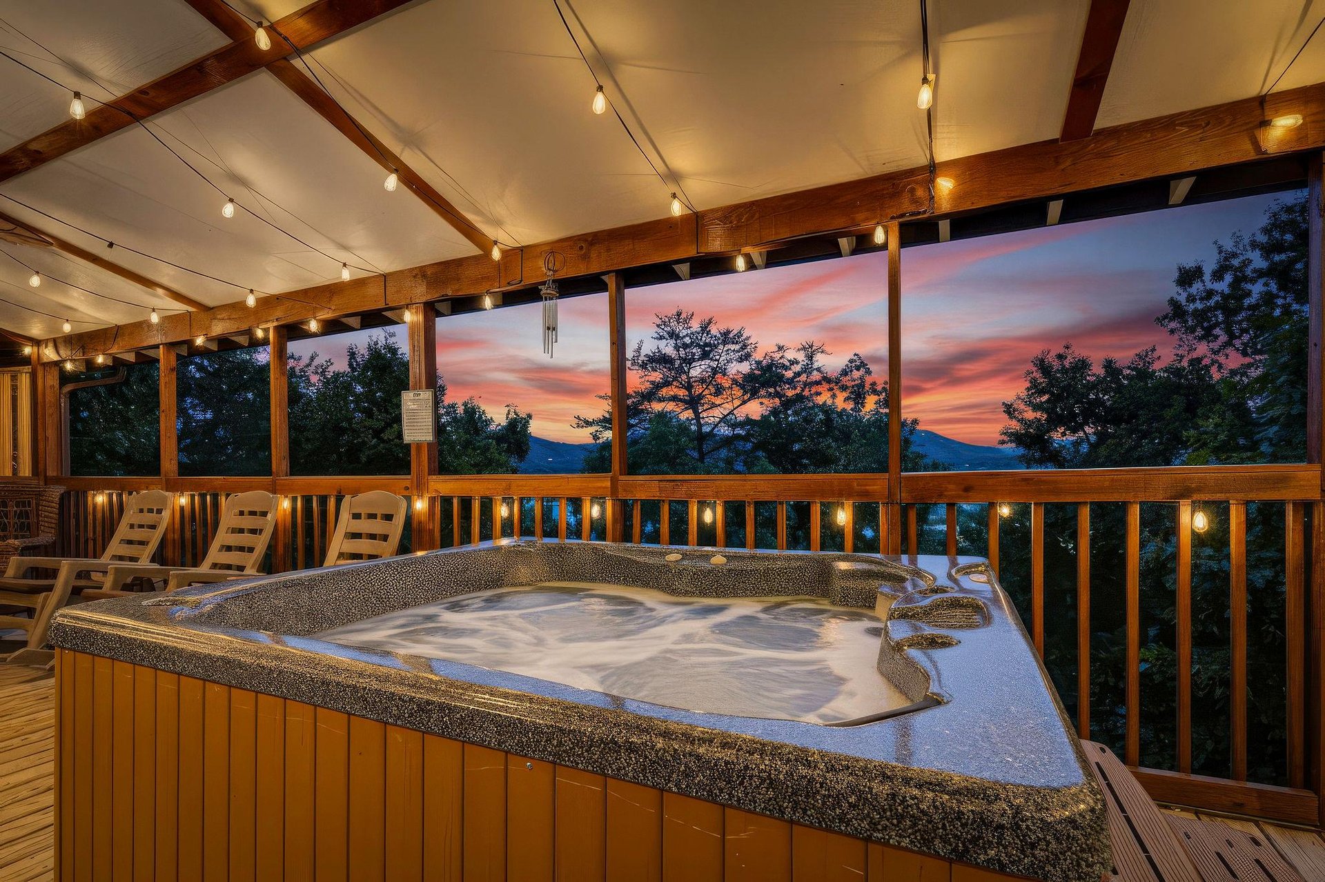 Soak away your cares in the hot tub while watching the sky blaze with color at sunset, framed by mountain silhouettes and treetops—your private escape under the stars.