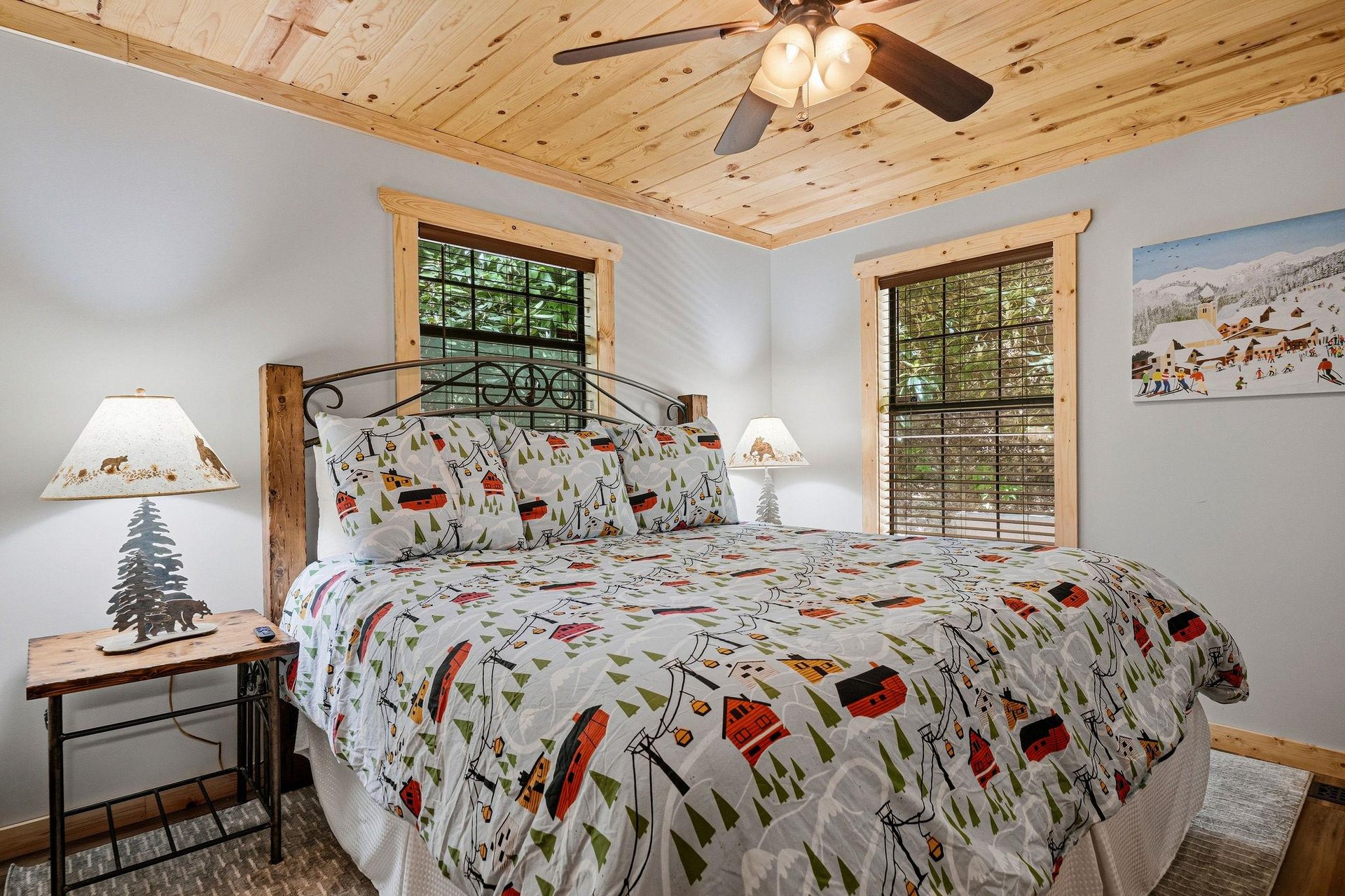 Your cozy bedroom features charming cabin touches, from the warm wood ceiling to playful outdoorthemed bedding. Natural light filters through bamboo blinds, creating a peaceful retreat for your mount