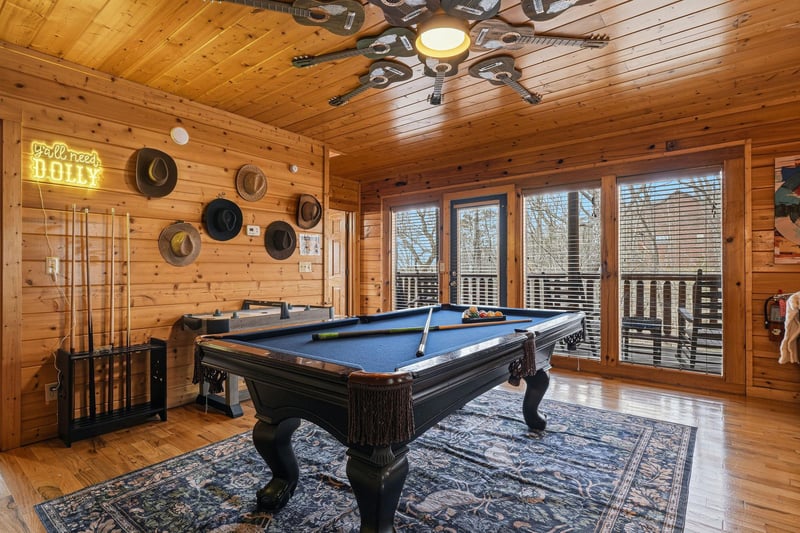 Challenge your group to friendly competition on your private pool table in this rustic game room with warm wood surroundings.