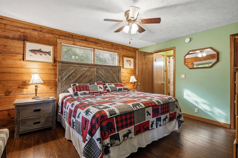 Unwind in this cozy cabin bedroom with rustic wood walls and charming wildlifethemed bedding that creates your perfect mountain retreat.