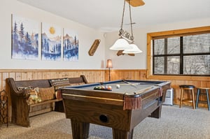 Gather around your private pool table for friendly competitions in this cozy game room with rustic charm and mountain views.
