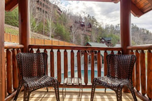 Relax on your private balcony with wicker chairs overlooking the peaceful mountain community and sparkling pool below.