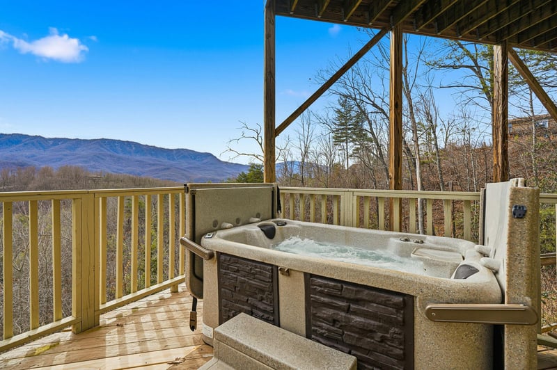 Soak in your private hot tub while enjoying breathtaking mountain views from your covered deck.