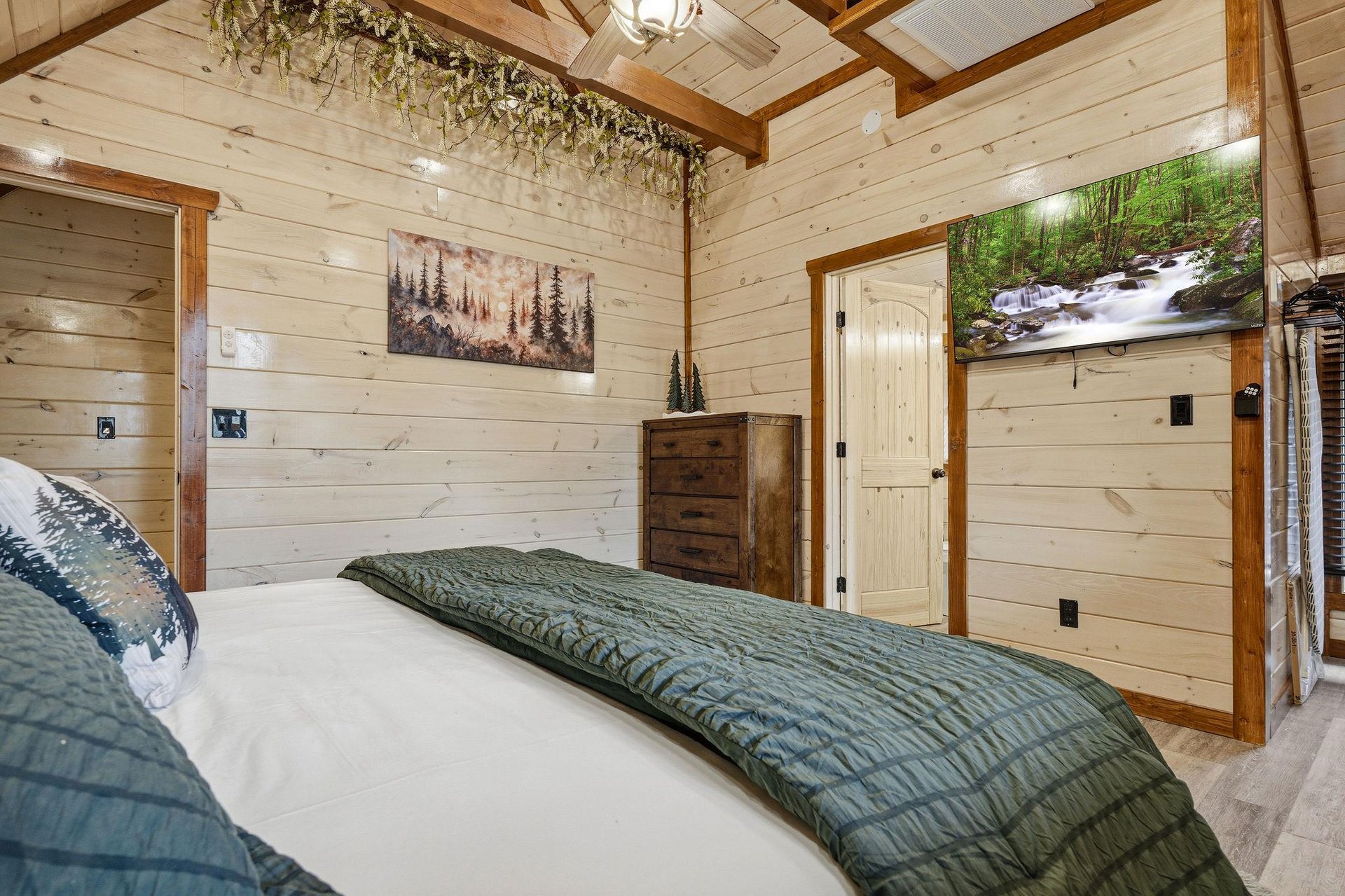 Drift off to sleep in your cozy cabin bedroom with rustic wood walls, natureinspired art, and peaceful forest vibes throughout.