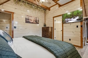 Drift off to sleep in your cozy cabin bedroom with rustic wood walls, natureinspired art, and peaceful forest vibes throughout.