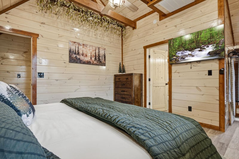 Drift off to sleep in your cozy cabin bedroom with rustic wood walls, natureinspired art, and peaceful forest vibes throughout.