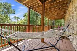 Settle into your hammock and let the forest breeze wash over you. This covered deck invites peaceful moments surrounded by lush trees and endless sky.