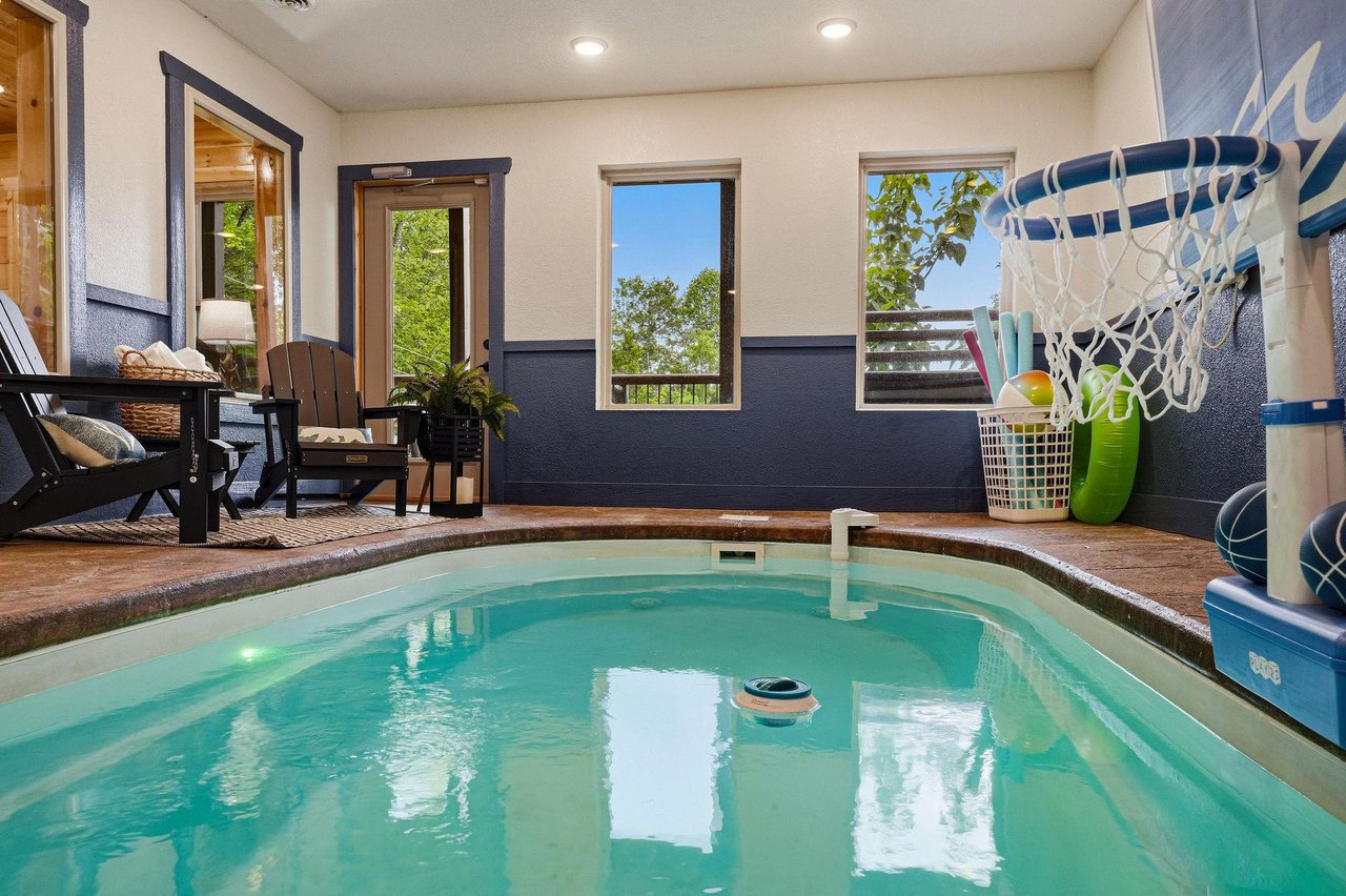 Slip into your private indoor pool anytime—warmed water, lounge seating, and a hammock swing create your own cozy escape, perfect for relaxing after exploring nearby adventures.