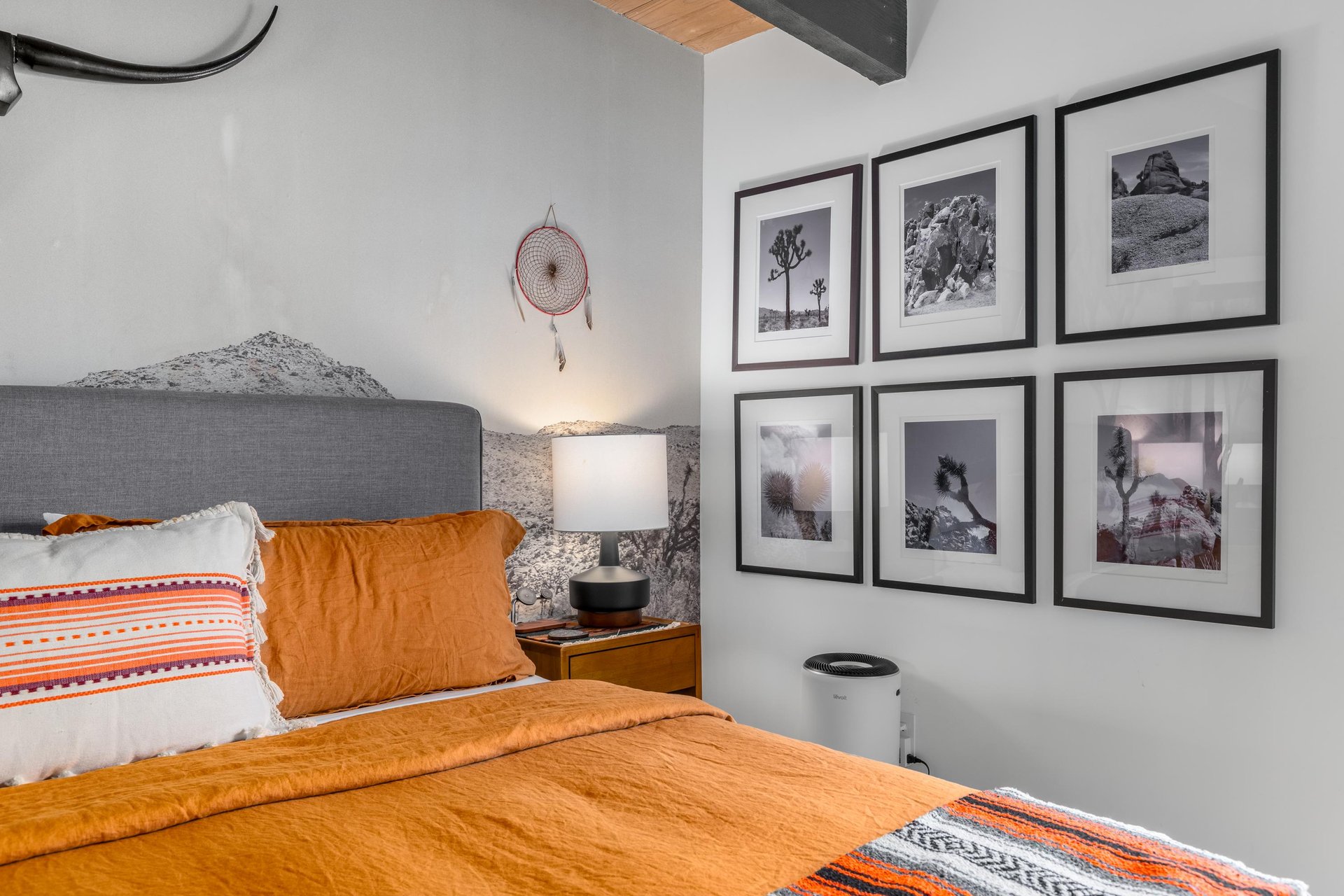 Rest peacefully in your cozy bedroom where desertinspired art and warm orange bedding create a southwestern sanctuary for your perfect getaway.