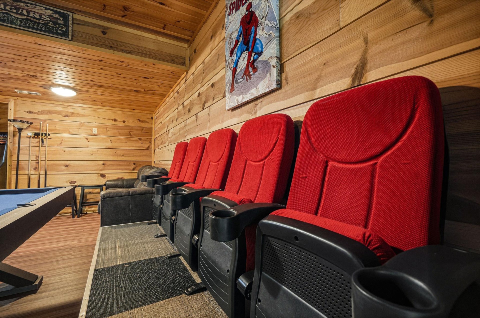 Your private theater awaits with plush stadium seating and classic movie decor, perfect for family movie nights in the comfort of your cabin retreat.
