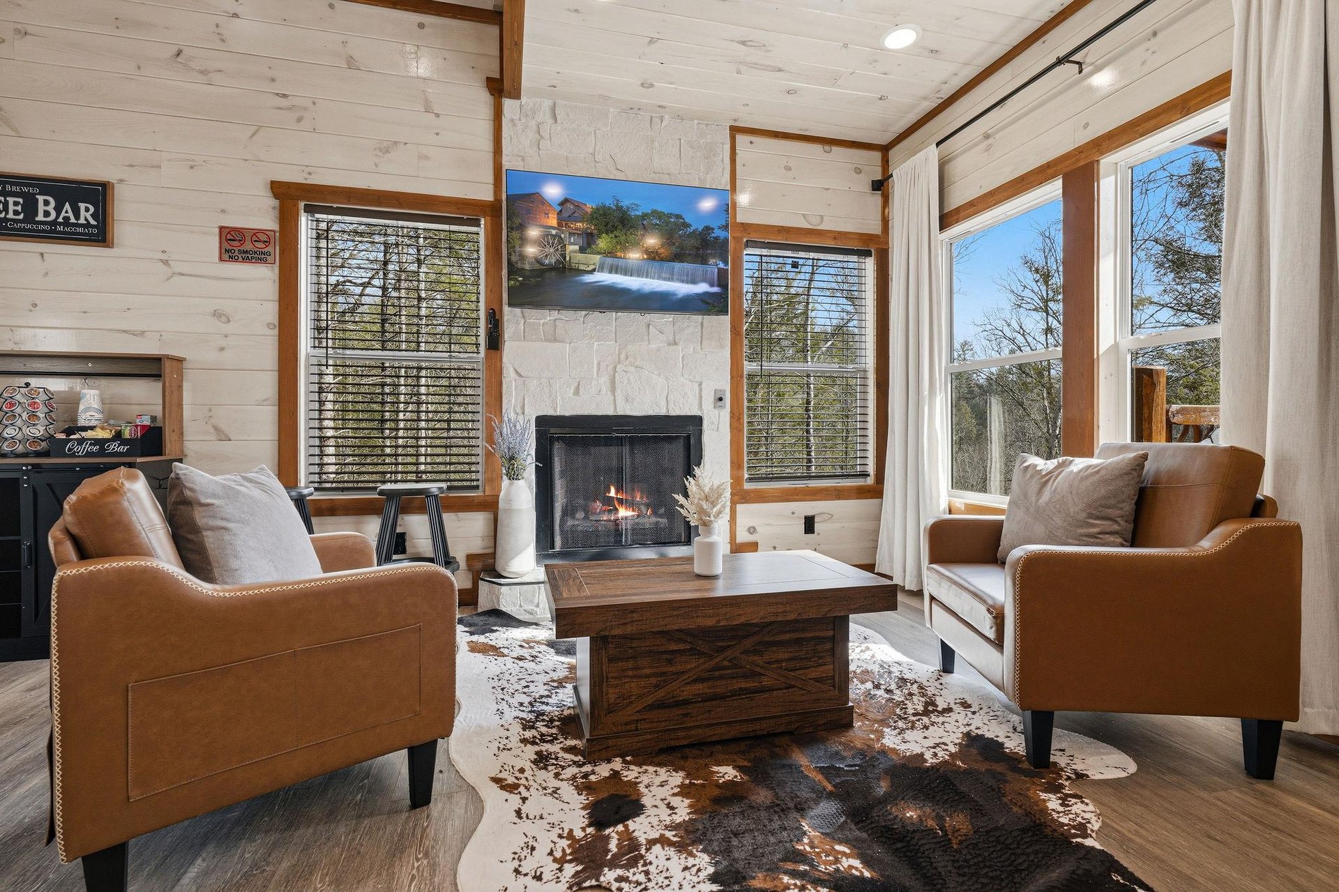 Sink into plush leather chairs by your crackling fireplace, where rustic wood beams and warm lighting create the perfect spot for evening relaxation.