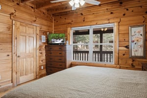 Drift off to sleep surrounded by warm pine walls and natural light streaming through your private balcony doors.