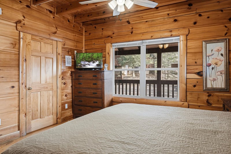 Drift off to sleep surrounded by warm pine walls and natural light streaming through your private balcony doors.