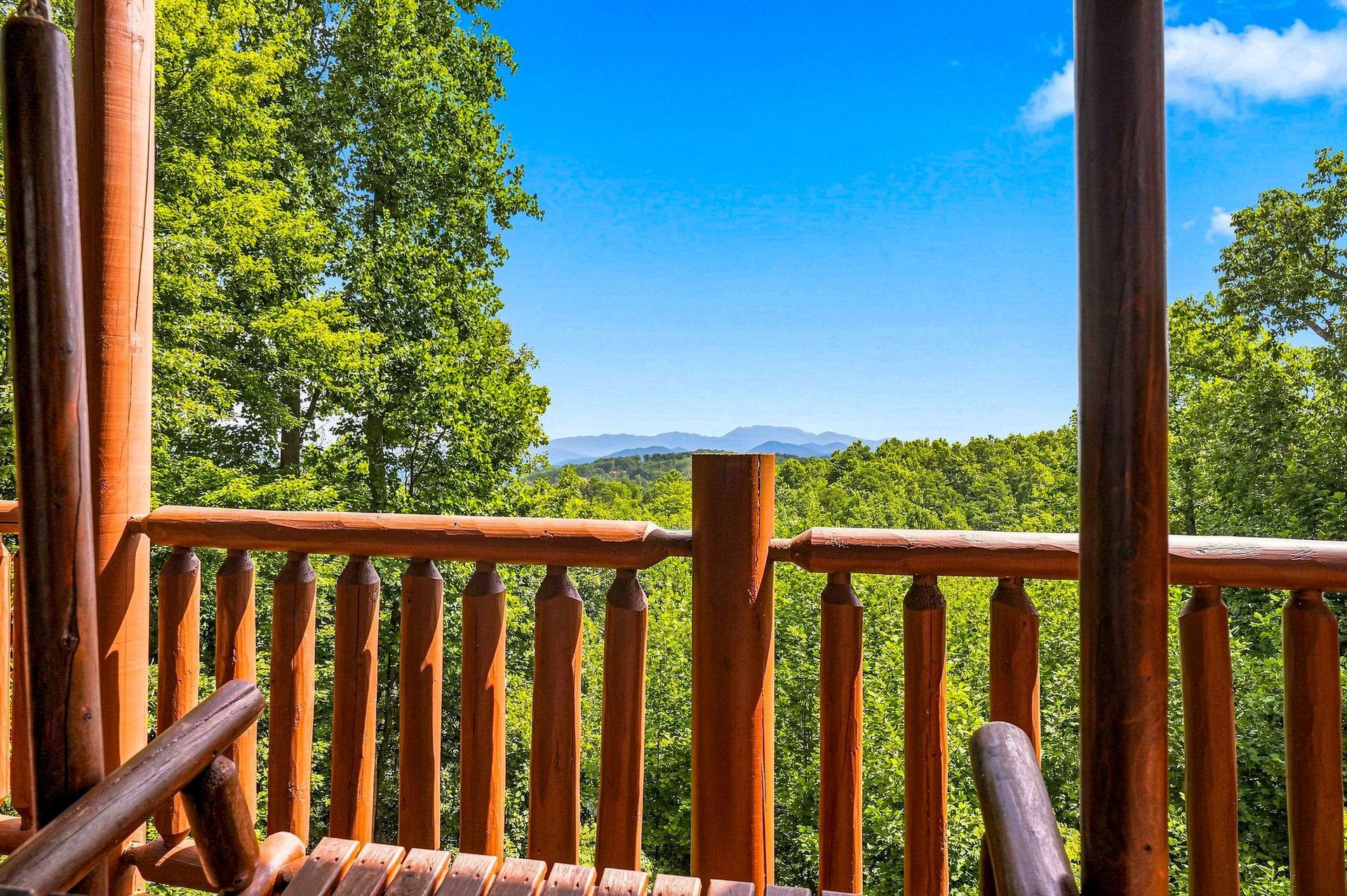 Gaze out from your private deck to layers of lush forest and serene mountain peaks in the distance.