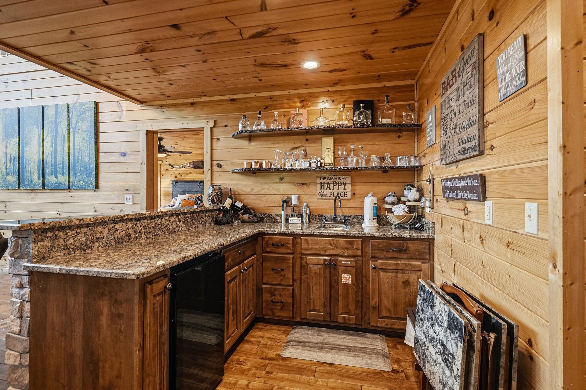Your rustic kitchen features granite countertops, warm wood cabinetry, and a charming bar setup perfect for making memories with friends and family.