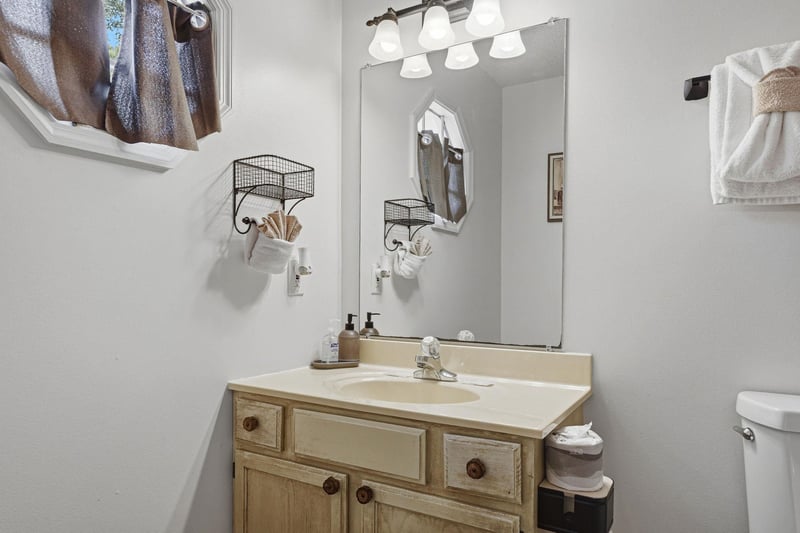 Step into your private bathroom featuring coastal charm with a seashelldecorated vanity, fresh towels, and thoughtful lighting to help you feel right at home.