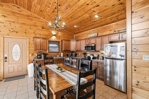 Your rustic kitchen features warm wood beams, full appliances, and a cozy dining table where youll savor meals together.