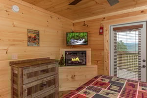 King bed with dresser and fireplace