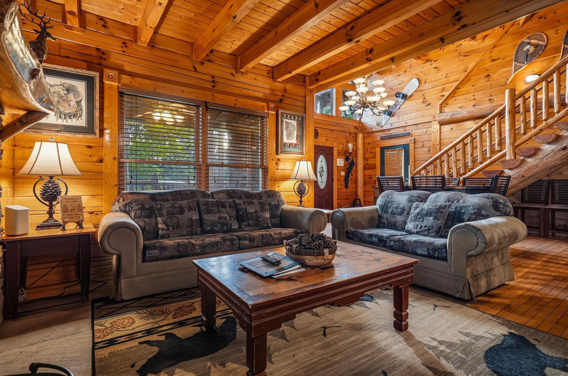 Step into your cozy cabin retreat with soaring pine ceilings, warm lighting, and plush seating where you can unwind after exploring the surrounding wilderness.