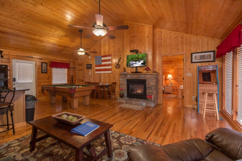 Living room with fireplace  TV at A Beary Cozy Escape, a 1 bedroom cabin rental located in Pigeon Forge
