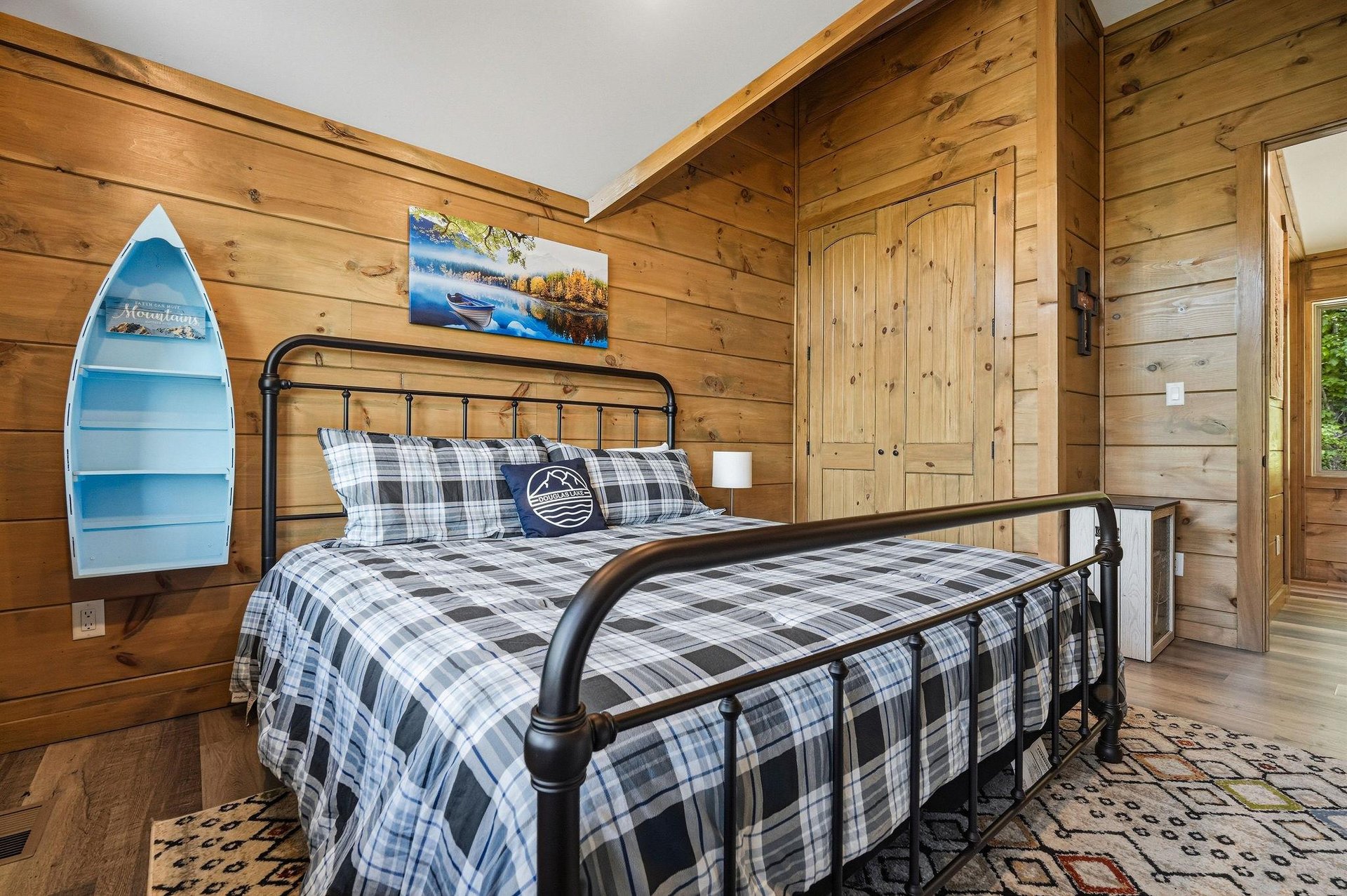 Drift off in your cozy lakeside retreat, where warm wood walls and nautical touches create the perfect cabin atmosphere for restful nights.