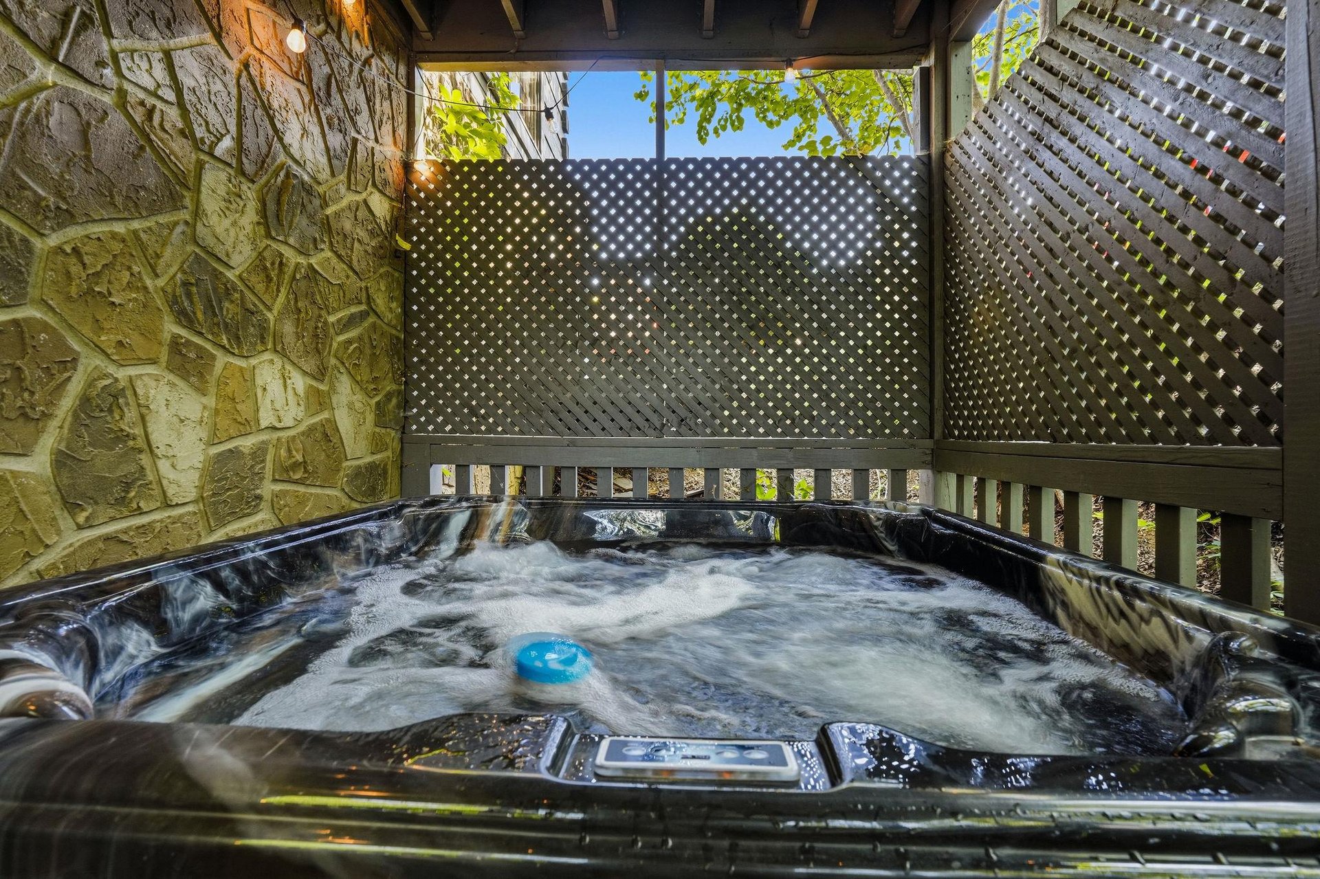 Soak your worries away in your private hot tub, sheltered by elegant stone walls and lattice screens for ultimate relaxation.
