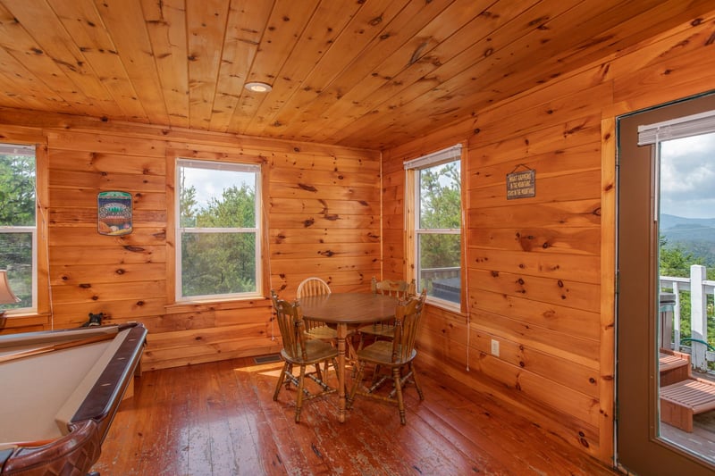 Table with four chairs in the game room at Black Bear Ridge, a 3bedroom cabin rental located in Pigeon Forge