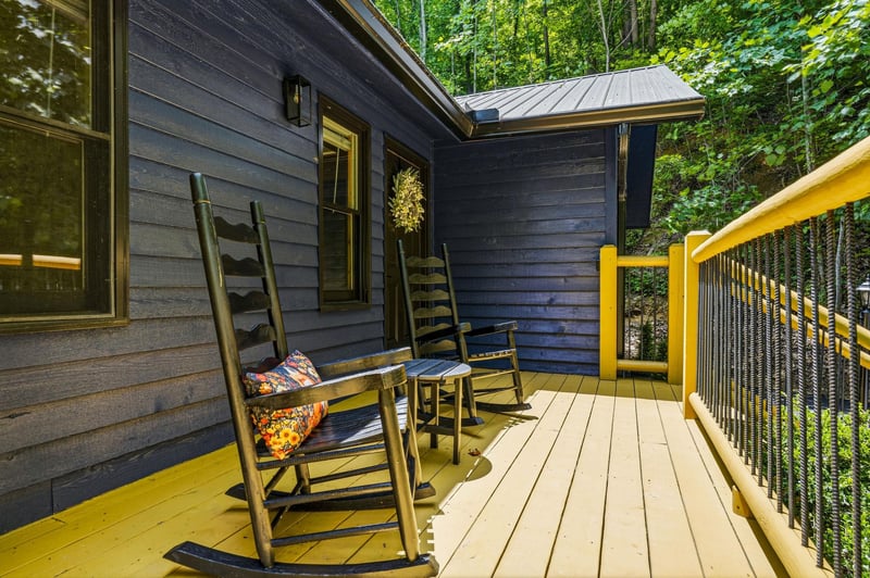 Relax on your private deck, where wooden rocking chairs and lush forest surroundings invite you to unwind with morning coffee or peaceful evening conversations.