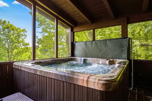 Soak in your private hot tub while surrounded by lush forest views through floortoceiling windows—your personal retreat for ultimate relaxation.