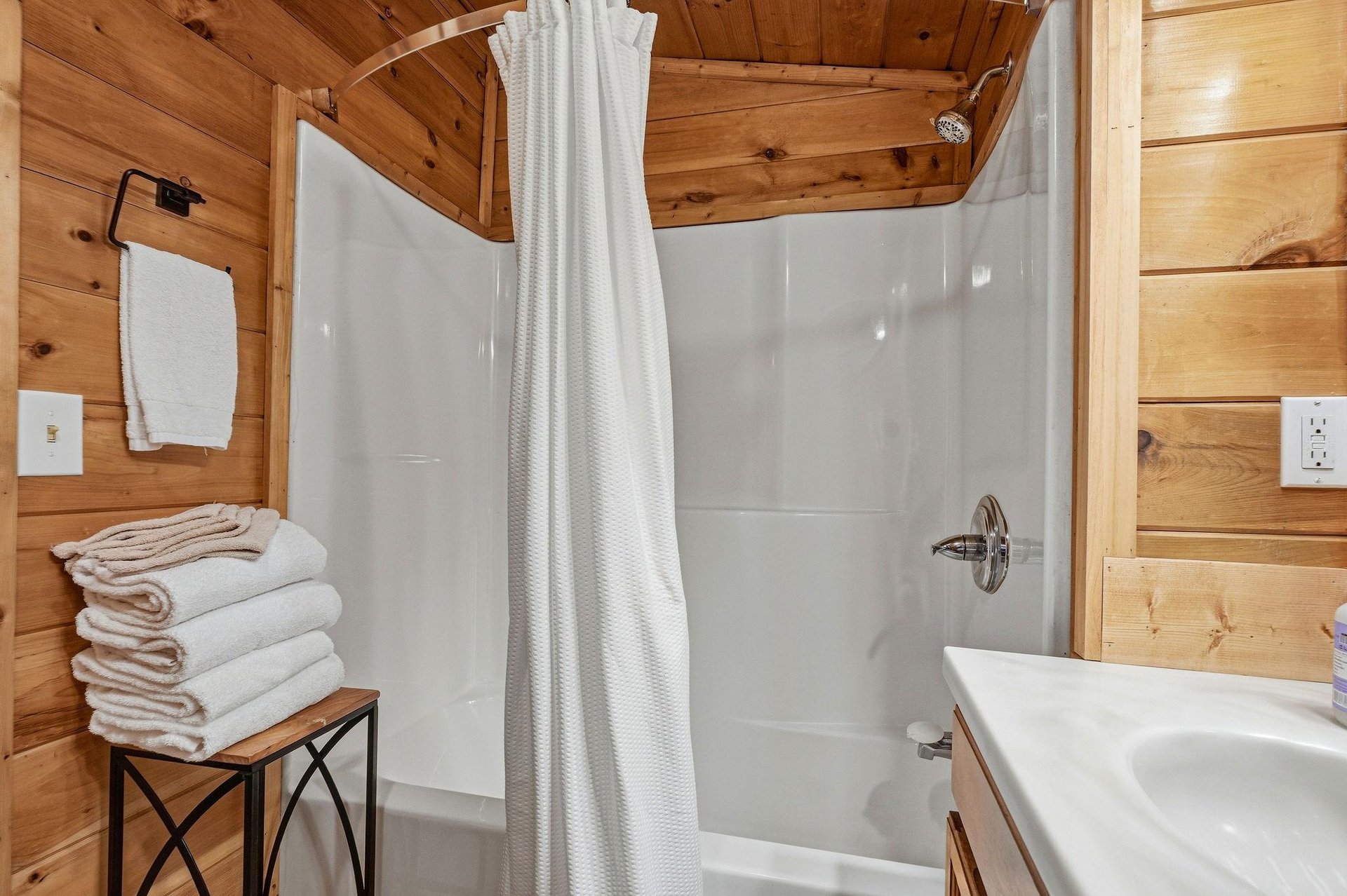 Unwind in your cozy cabin bathroom with fresh towels and a relaxing shower after mountain adventures.