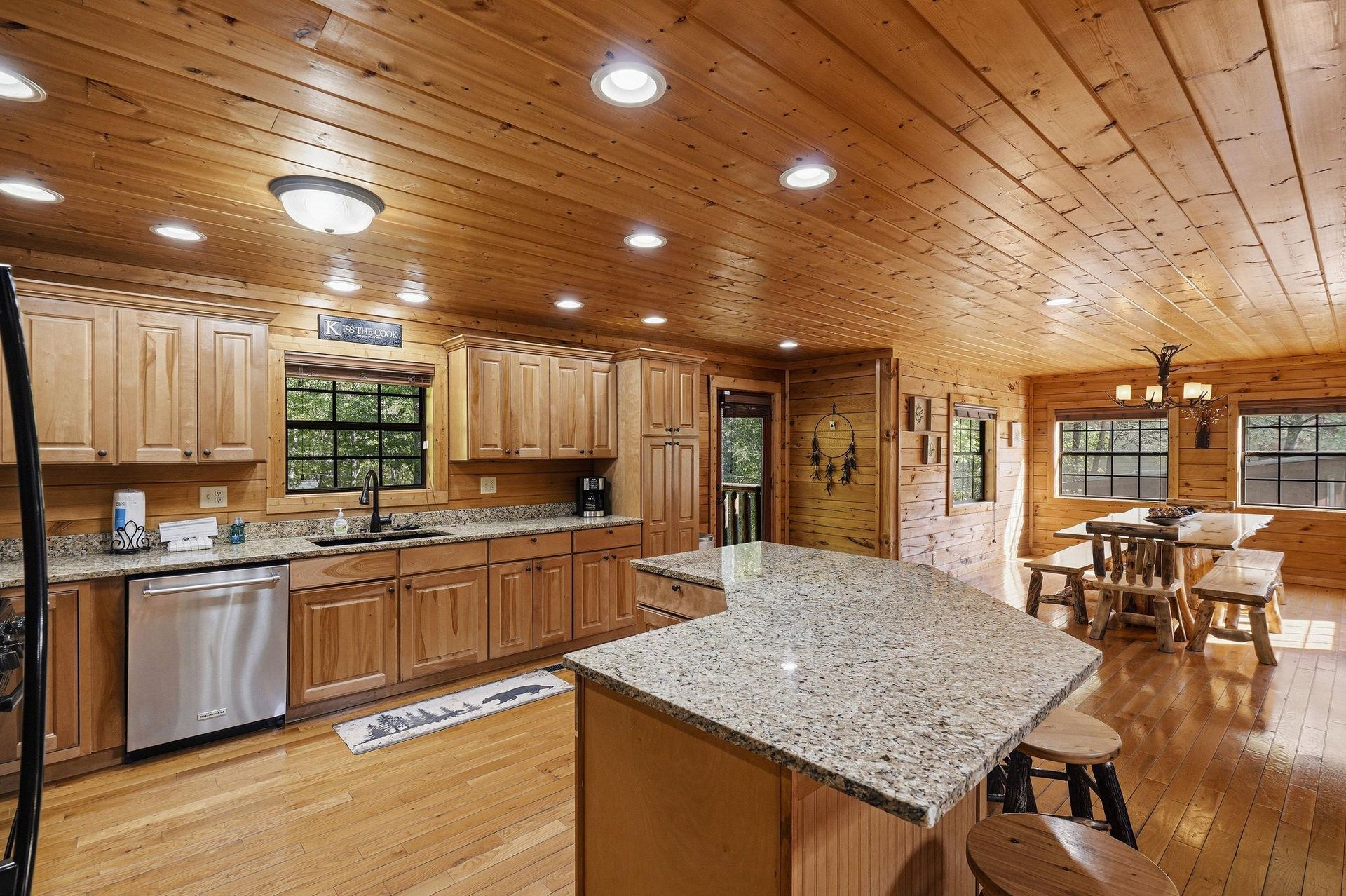Your fullyequipped kitchen invites mountain cooking adventures with granite counters, modern appliances, and rustic wood charm throughout.