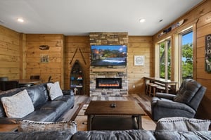 Sink into plush leather seating around the crackling fireplace, where warm wood surrounds you and lake views beckon through windows.