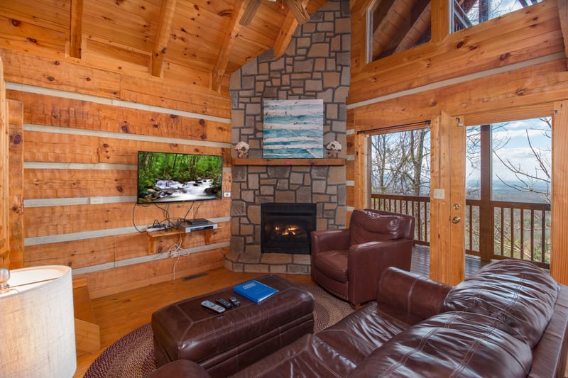 Living room with fireplace and TV at EllaVation, a 3 bedroom cabin rental located in Gatlinburg
