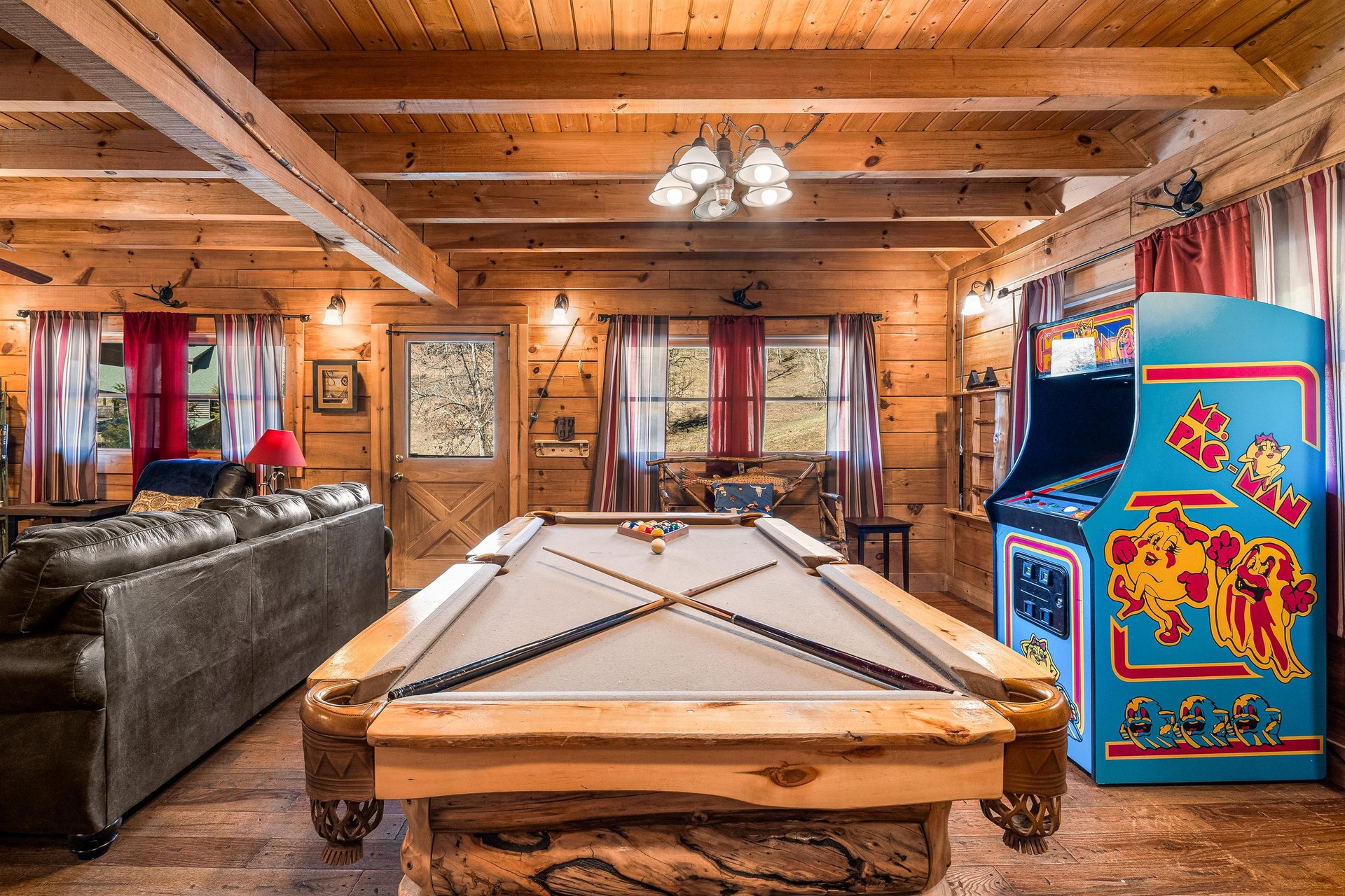 Pool table and arcade game at A Beary Nice Cabin, a 2 bedroom cabin rental located in Pigeon Forge