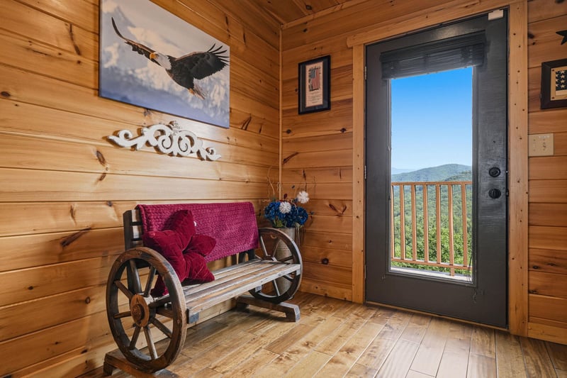 Step through the door to stunning mountain vistas framed by your private deck railing—this welcoming entryway sets the tone for your peaceful cabin retreat.
