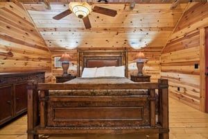 Unwind in your rustic log cabin bedroom, where handcrafted furniture and warm wood create the perfect mountain retreat atmosphere.