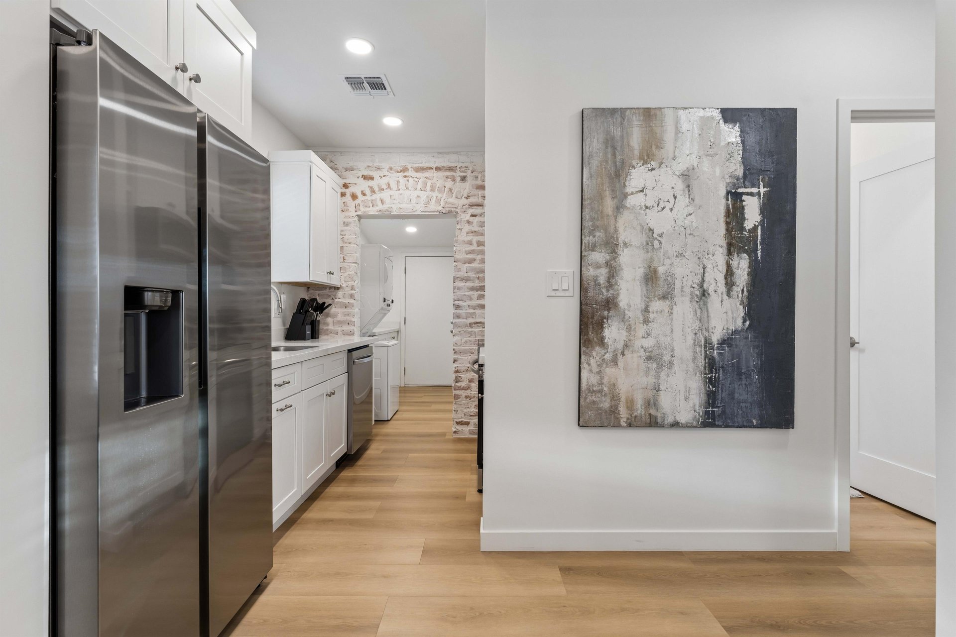 Stainless steel appliances, cooking essentials, and easily accessible dining space.
