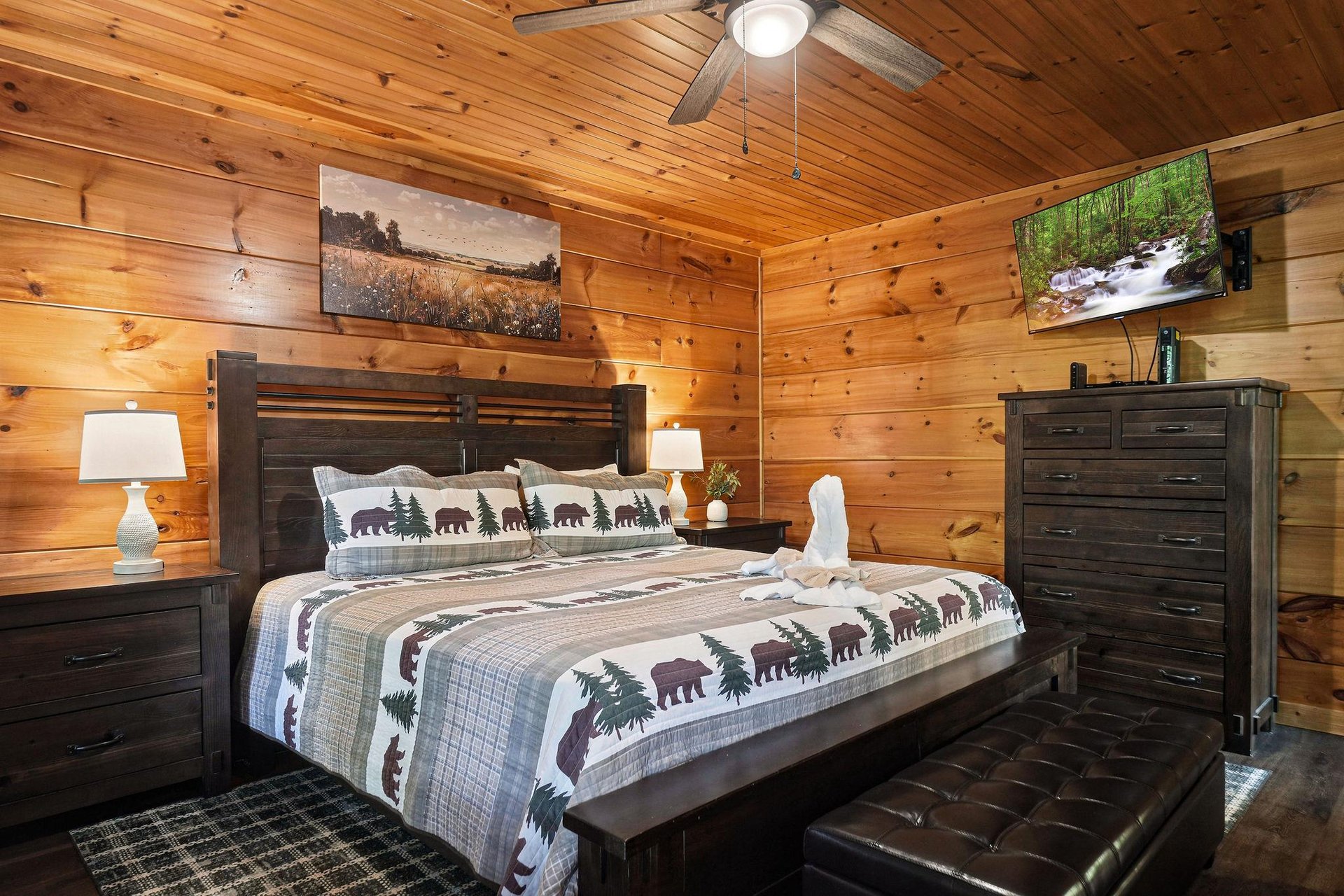 Sink into your cozy cabin bedroom featuring rustic woodpaneled walls, plush wildernessthemed bedding, and nature artwork that brings the outdoors inside.