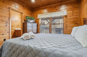 Sink into the plush bedding and wake to peaceful wooded views from your private retreat. Rustic wood walls and thoughtful touches make this your cozy mountain escape.