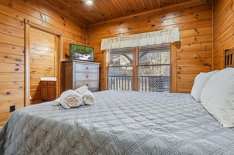 Sink into the plush bedding and wake to peaceful wooded views from your private retreat. Rustic wood walls and thoughtful touches make this your cozy mountain escape.