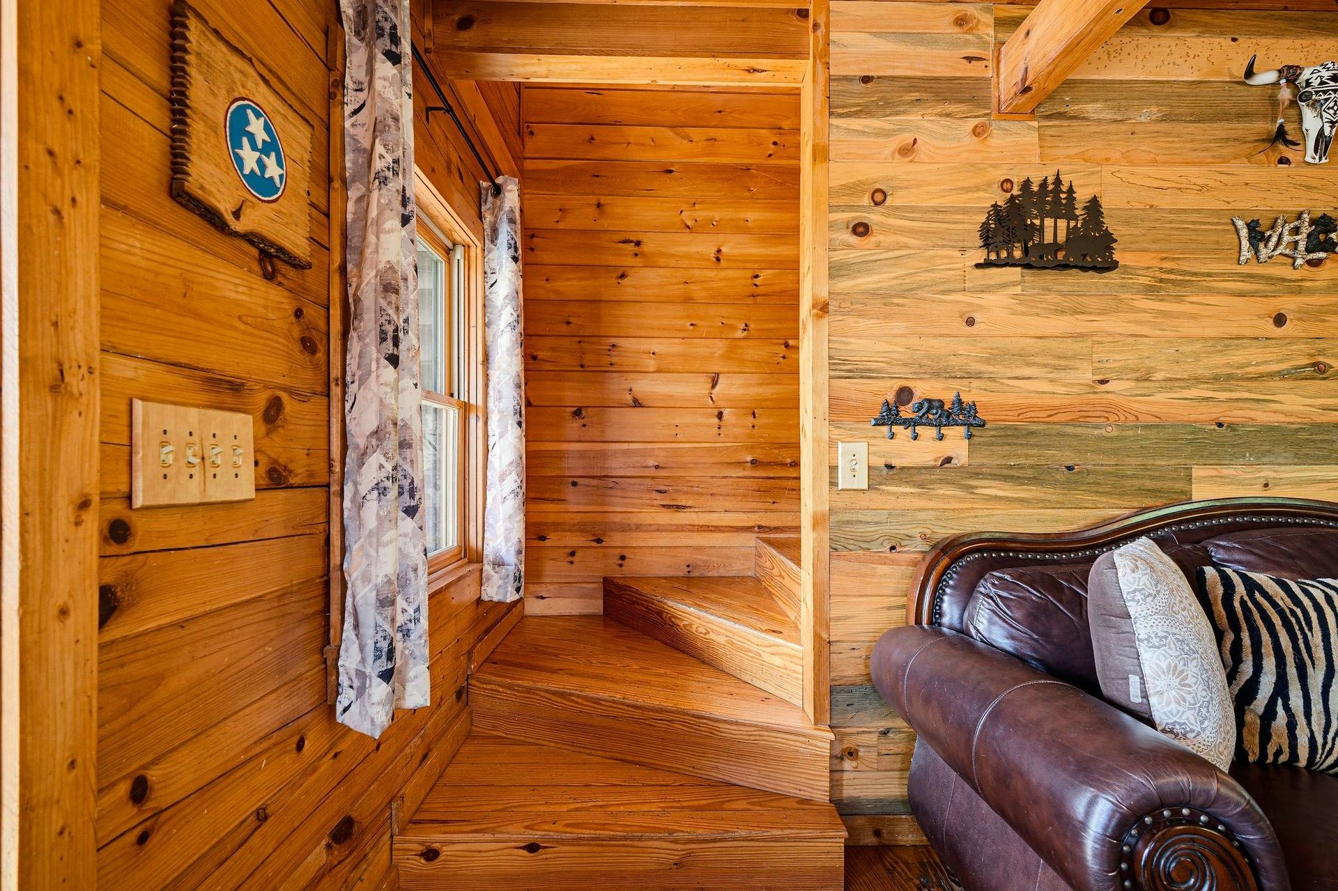 Step into your cozy cabin retreat, where warm wood walls and rustic décor create the perfect mountain escape for your stay.
