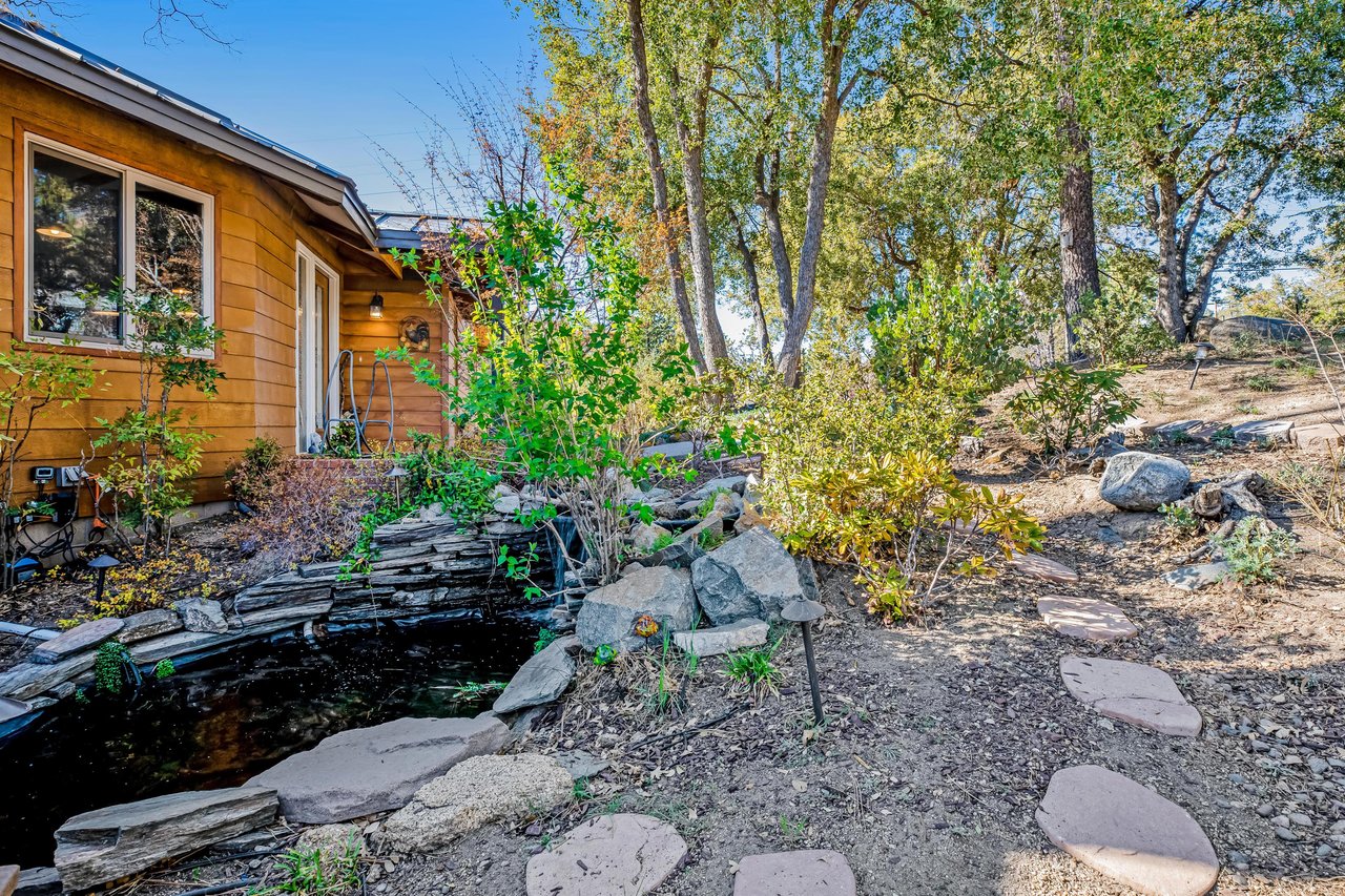 Koi pond and pathway leading to the front of the home.