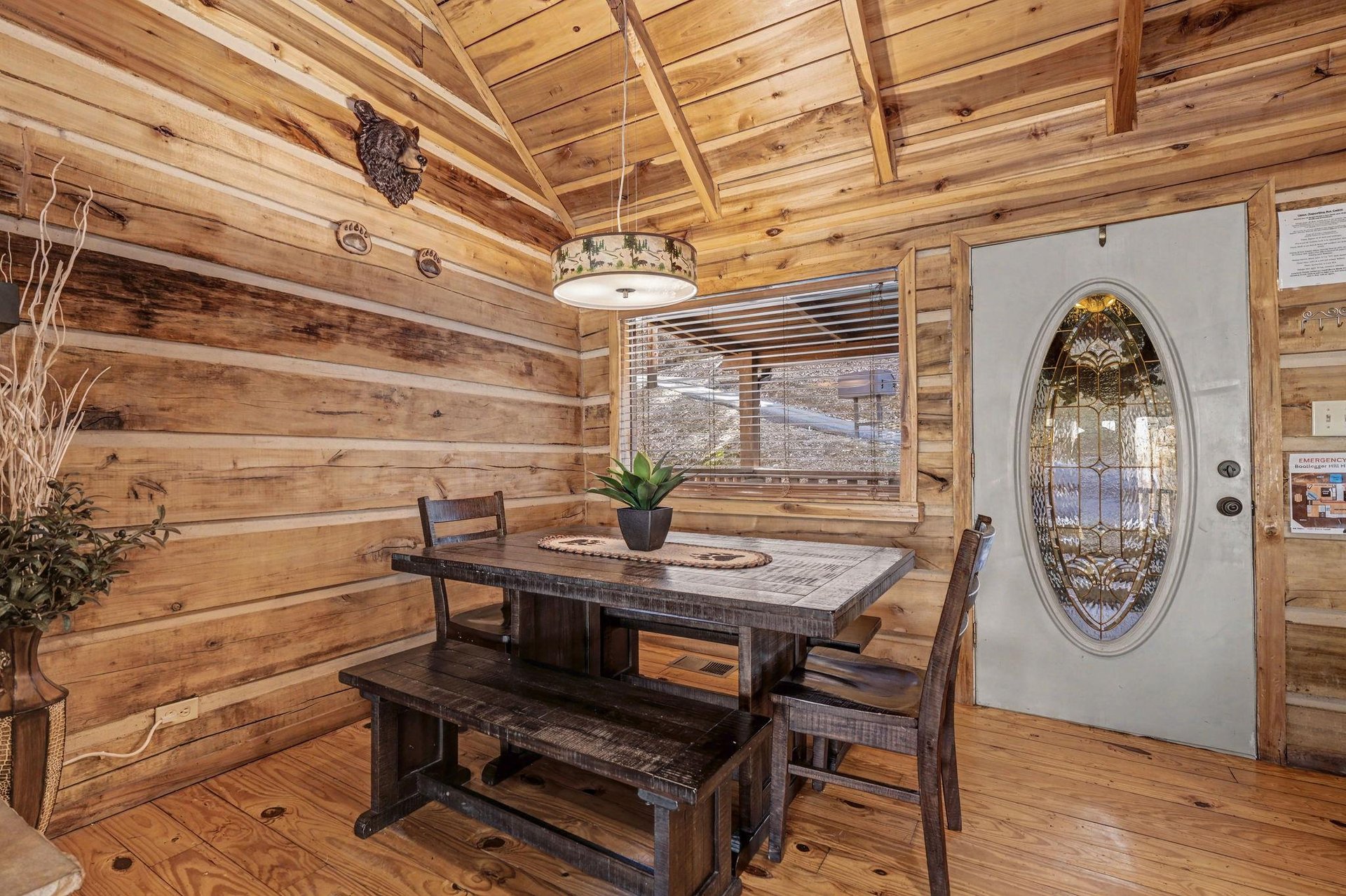 Step into rustic charm where handcrafted wood beams frame your dining moments beneath warm cabin lighting.