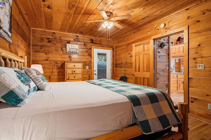 Unwind in your cozy cabin bedroom, wrapped in the warmth of natural knotty pine and soft linens, with rustic charm all around you.