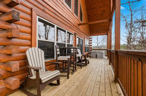 Step onto your private wooden deck where cozy Adirondack chairs await your morning coffee and peaceful moments surrounded by nature.