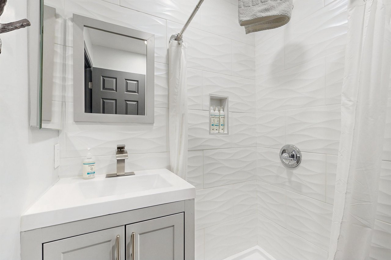 Full guest bathroom with a stand alone shower located near the 2 guest bedrooms.