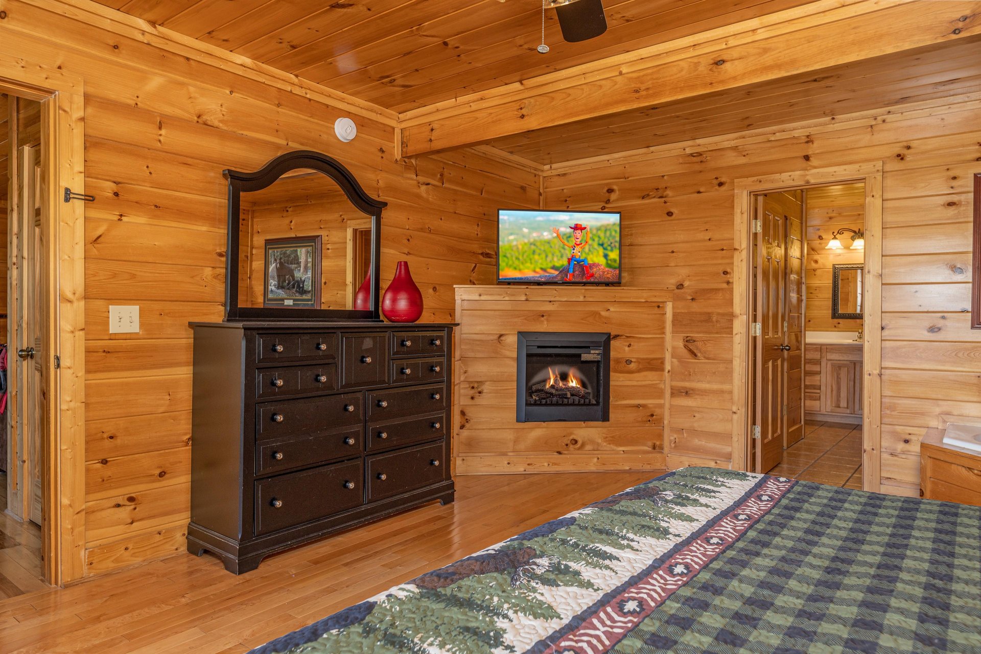 Dresser, fireplace, and TV in a bedroom at Bears Dont Bluff, a 3 bedroom cabin rental located in Pigeon Forge