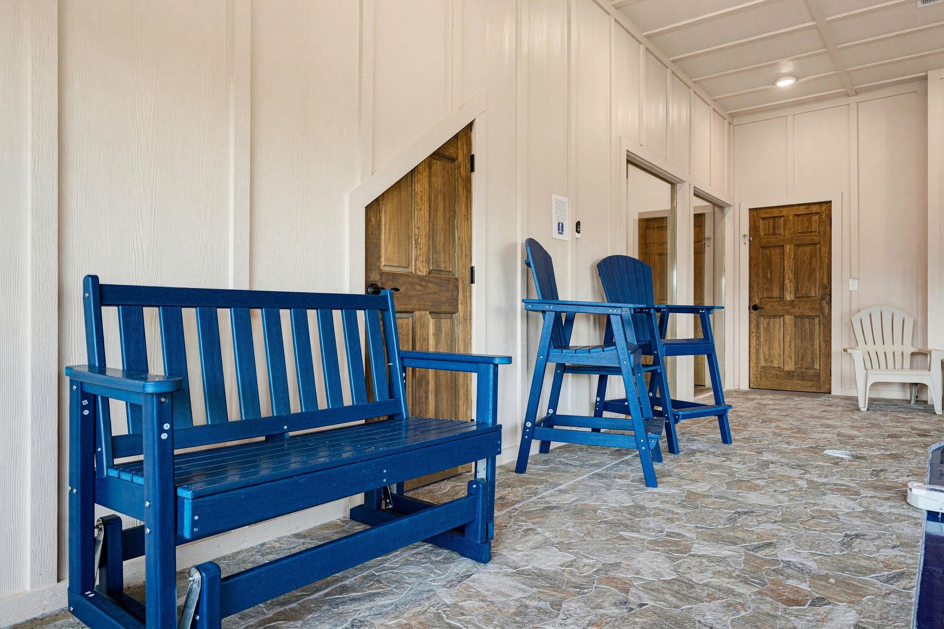Your private covered porch welcomes you with coastalblue seating—perfect for morning coffee or evening conversation in the fresh air.